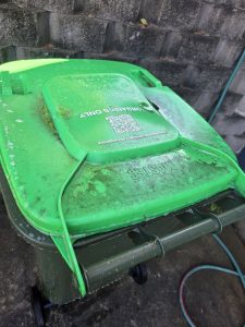 Green wheelie bin lid before cleaning