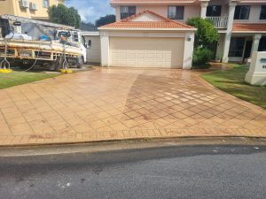 Exposed aggregate side path before and after pressure washing