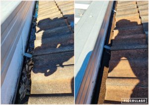 Gutter and roof edge with leaf debris before cleaning