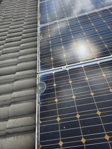 Solar panel before cleaning, close-up on tile roof
