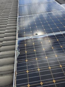 Solar panel after cleaning, close-up on tile roof