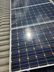 Solar panel close-up, metal roof edge, before and after cleaning